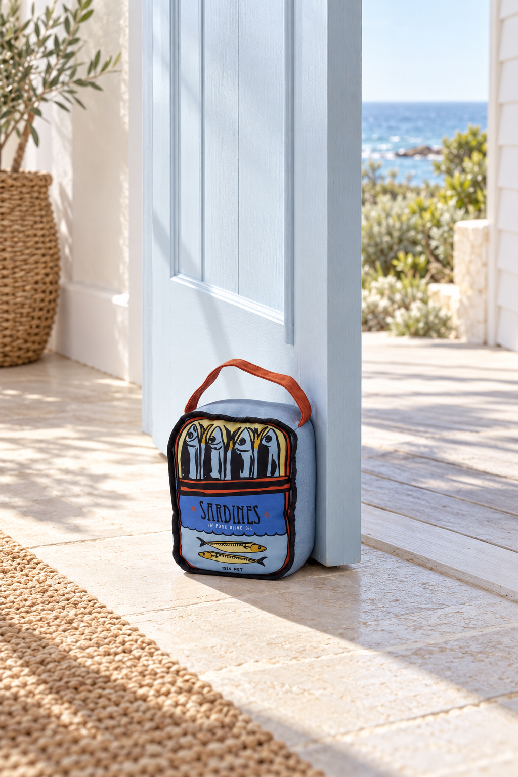 Sardines Novelty Door Stop holding open a door in a coastal home