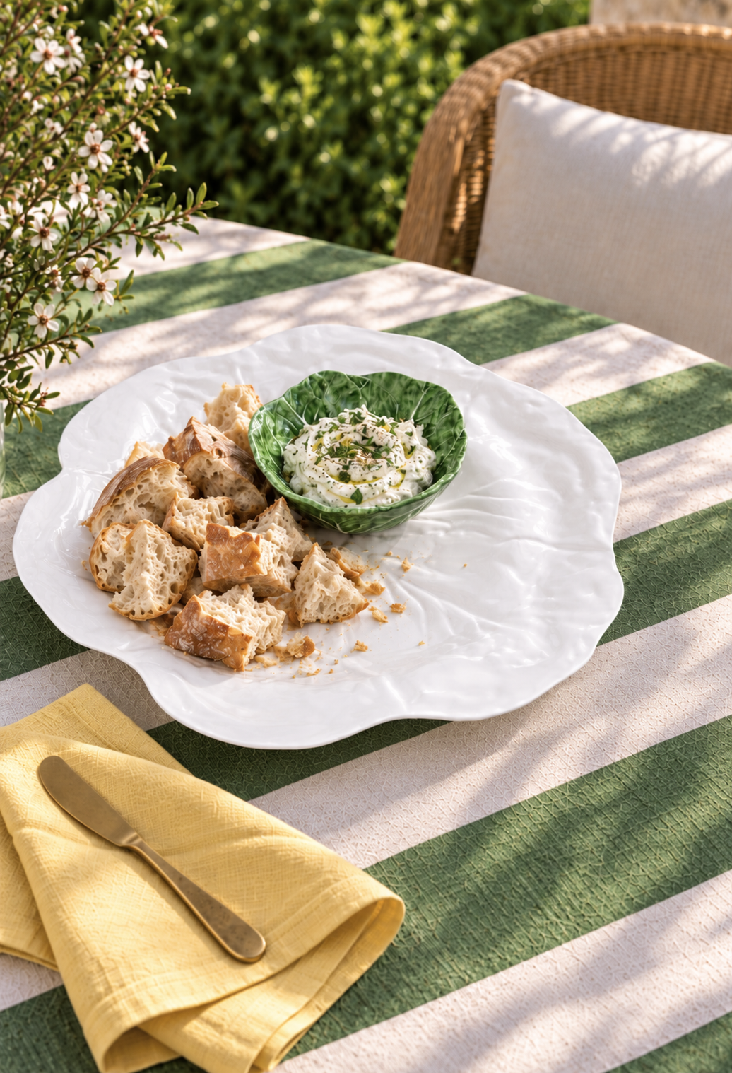 White Deep Platter – Cabbage Melamine styled with bread and dip on a green and white striped tablecloth