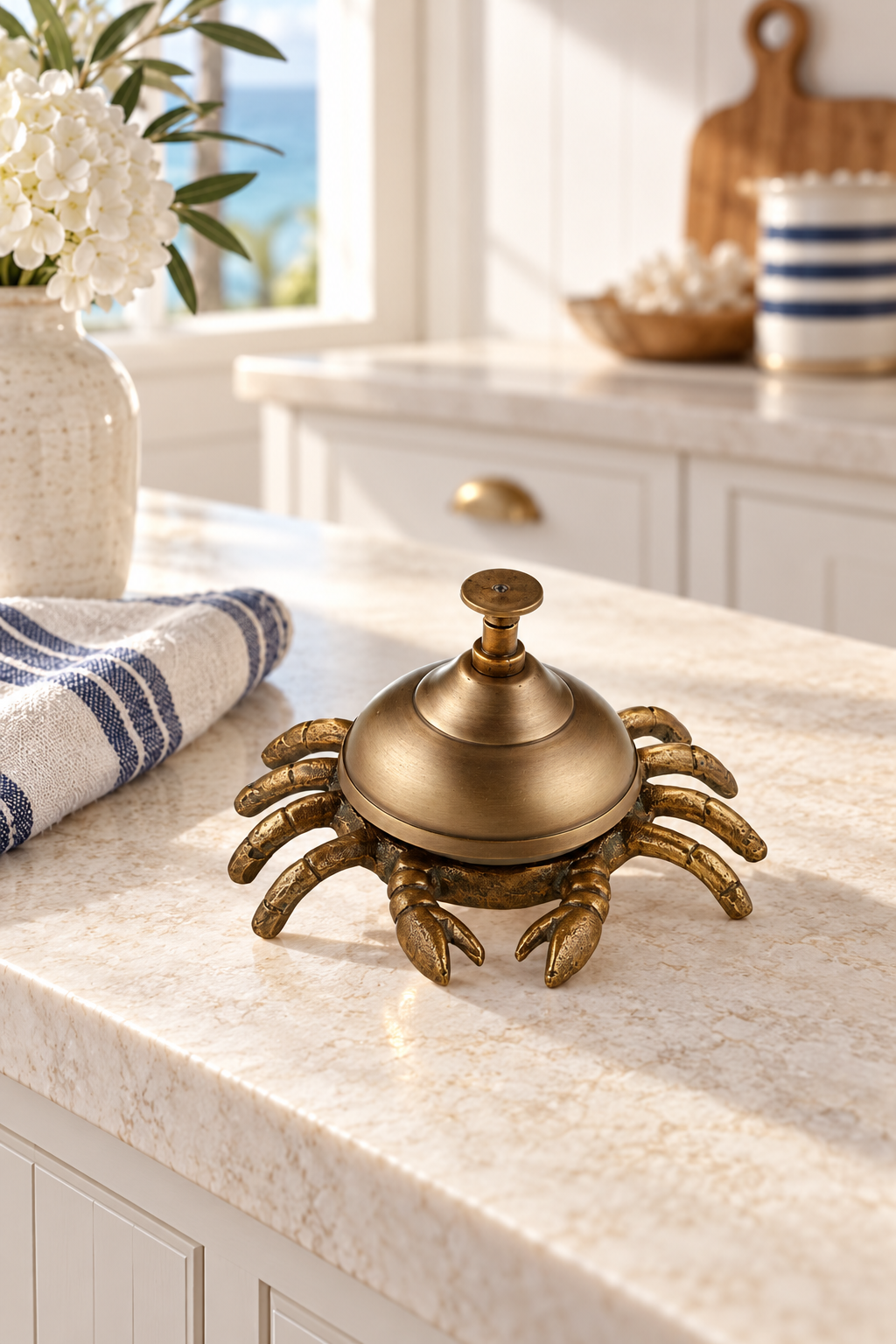 Brass crab table bell styled in a coastal kitchen