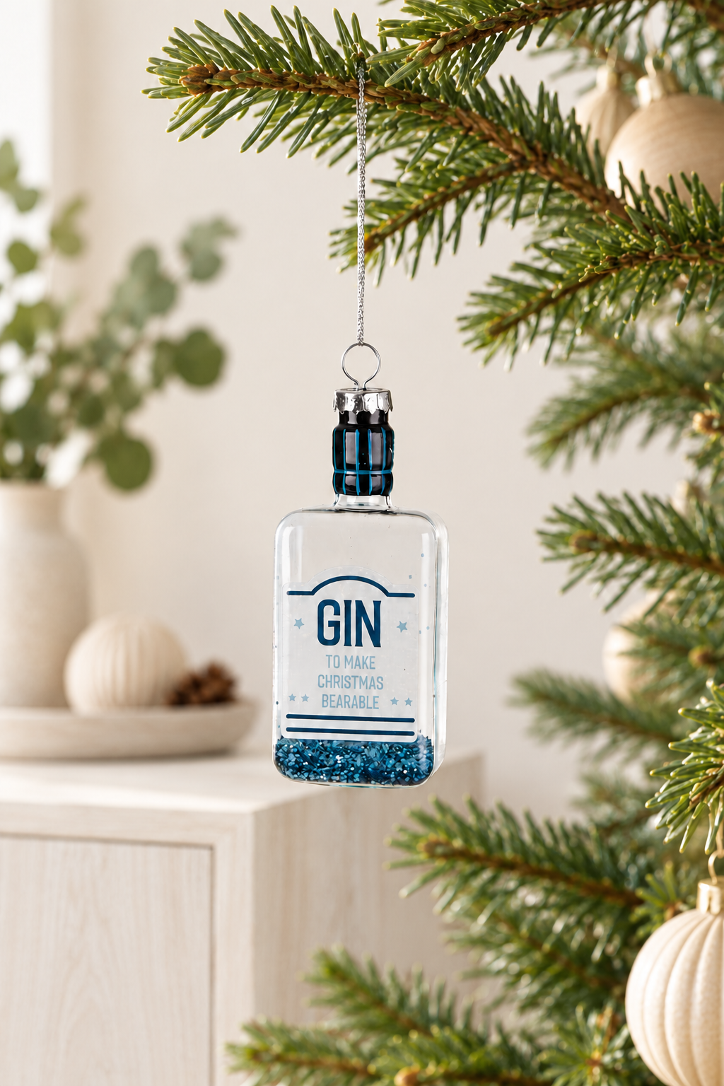 Gin Bottle Glass Tree Ornament - Blue styled indoors with pale whitewashed furniture and summer light; Coast to Coast XX10344