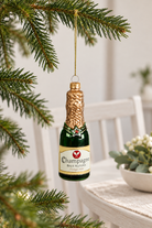 Champagne Bottle Glass Bauble - Green styled indoors with pale whitewashed furniture and summer light; Coast to Coast XX10834