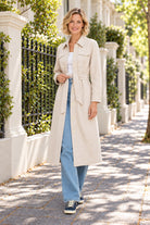 365 DAYS Erika Trench Coat - Vanilla Cream styled on a sunlit street