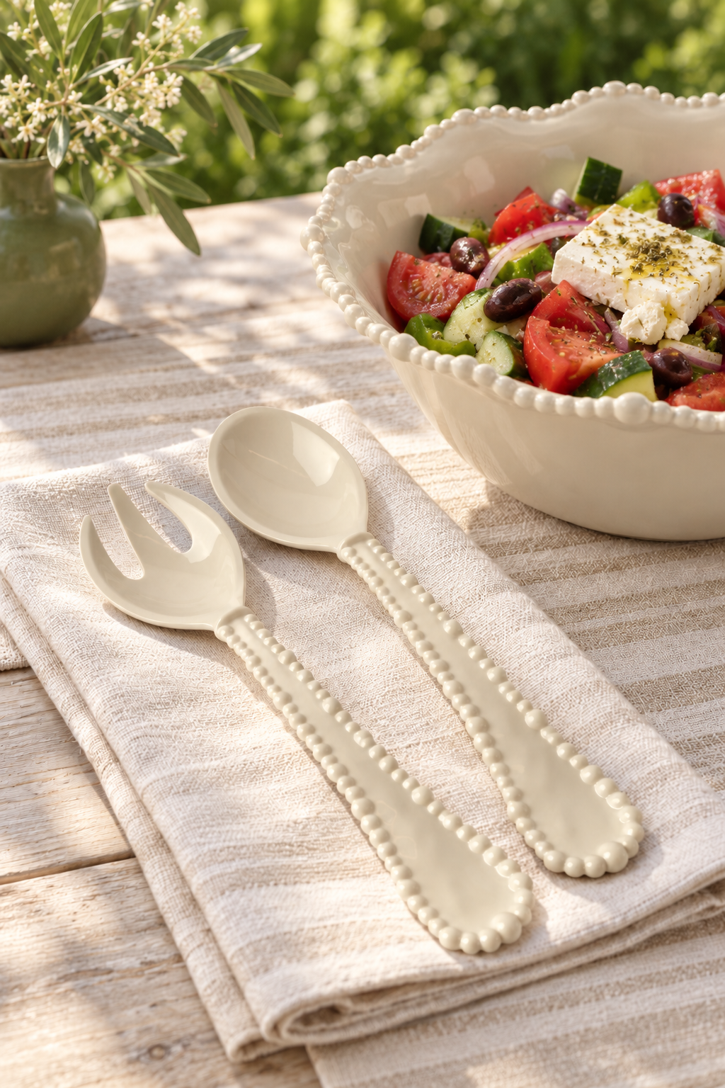 Sand Pearl salad servers and jumbo bowl of Greek salad in a garden