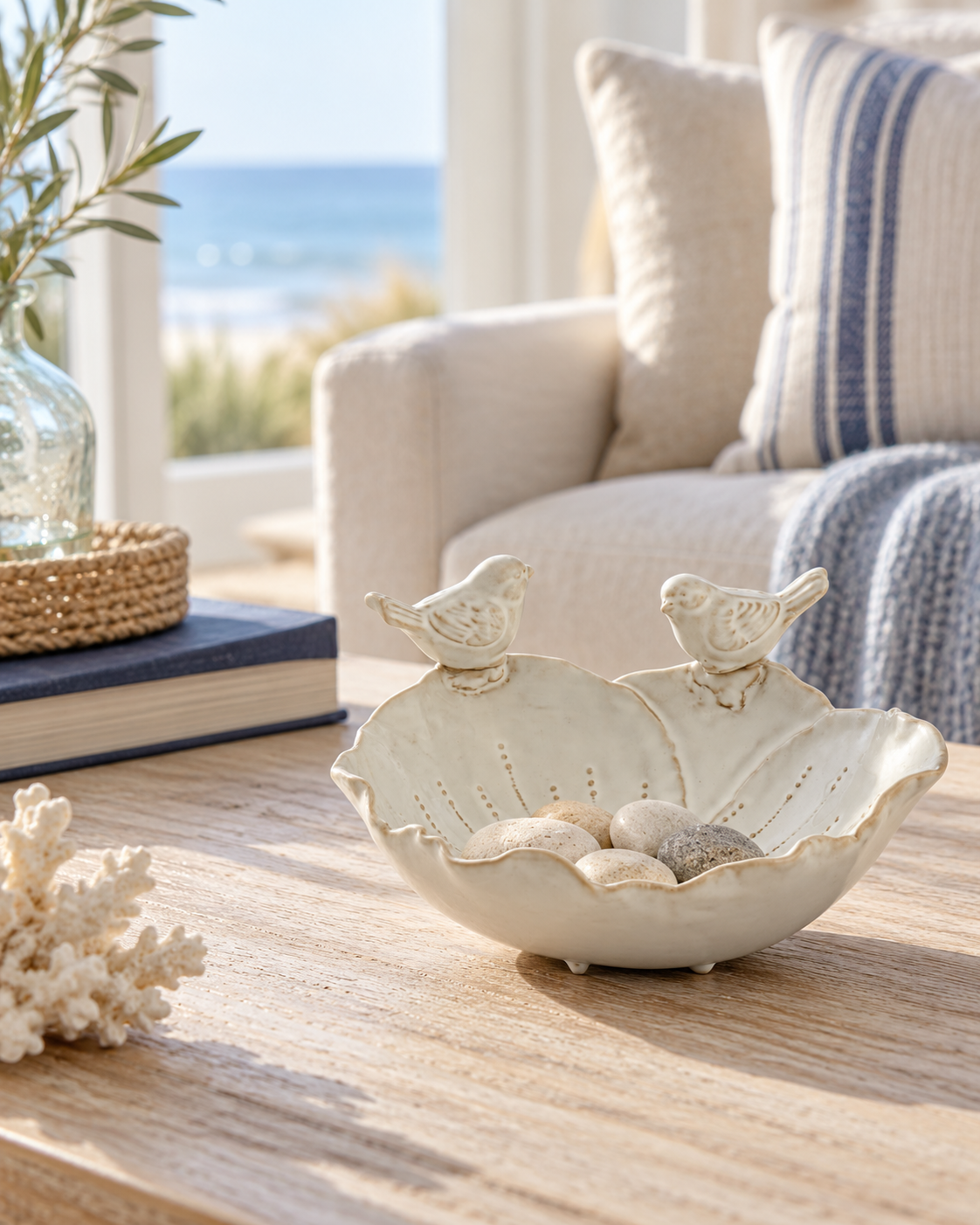 Cream bird decorative bowl styled in a light coastal sitting room