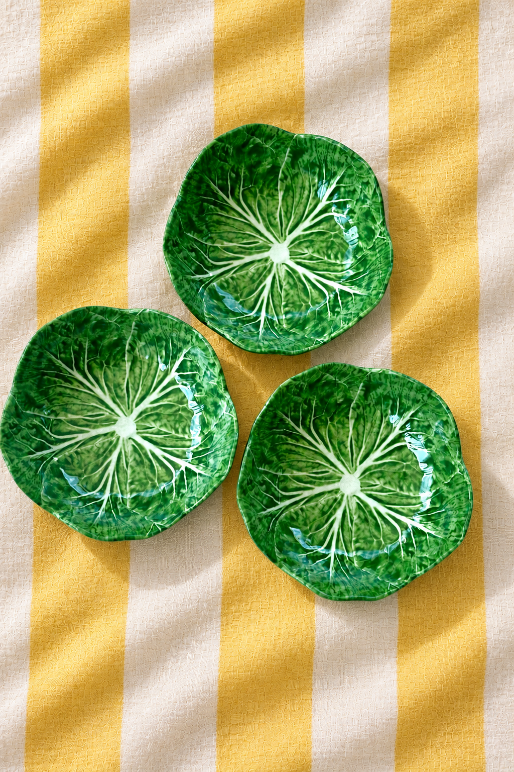 Green Baby Bowl – Cabbage Melamine on yellow and white striped tablecloth
