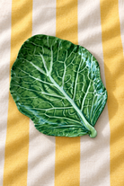 Green Stemmed Platter – Cabbage Melamine on yellow and white striped tablecloth