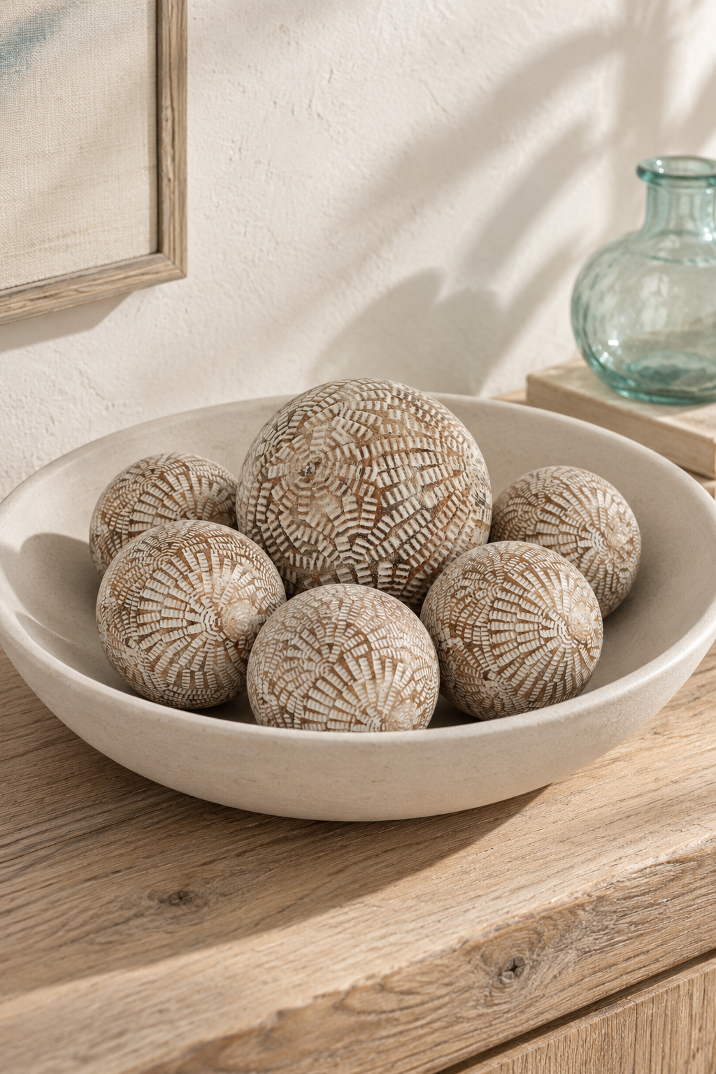 Mandalay 7 centimetre carved wooden balls with a 10 centimetre companion in a shallow bowl