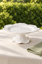 White Cabbage Melamine cake stand, empty, styled outdoors with green linen
