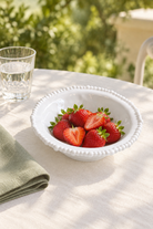 White Pearl Melamine side bowl styled with strawberries outdoors