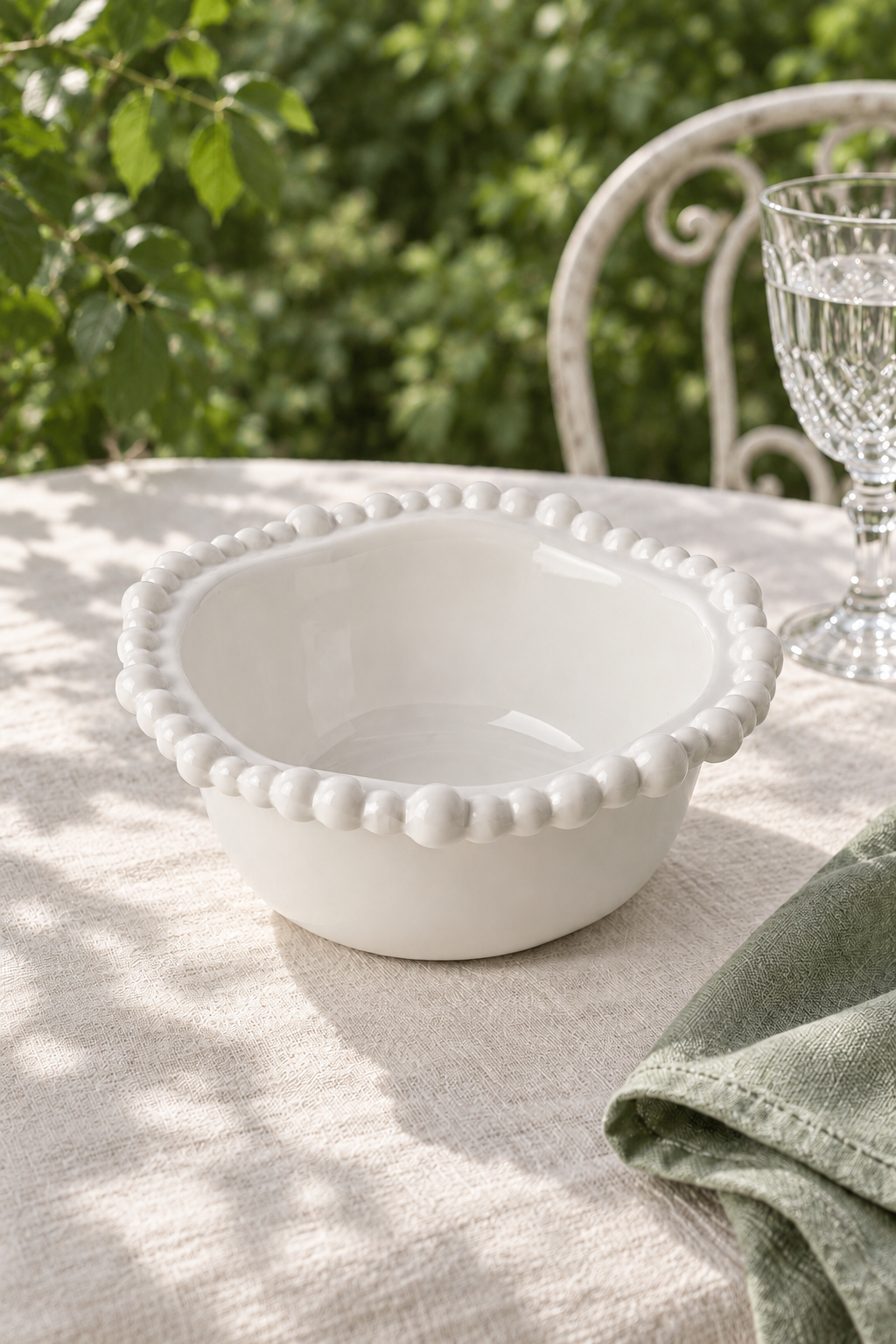 White Pearl Melamine small snack bowl styled outdoors with green linen